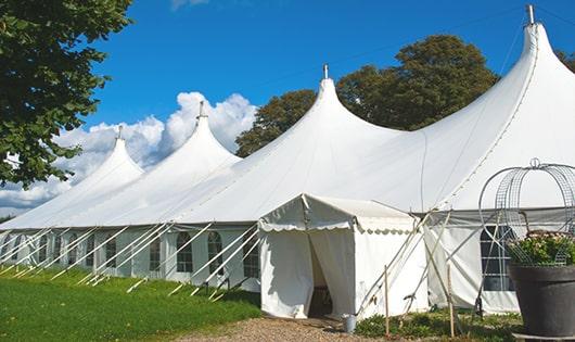 a group of luxury portable restrooms with individual stalls and running water in Hopedale